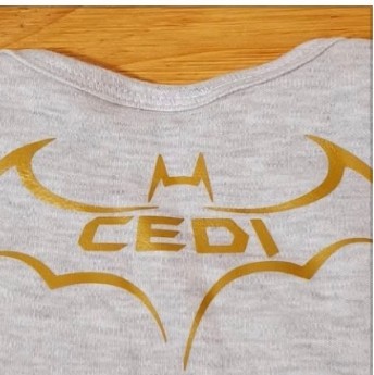 Grey shirt with a gold bat emblem and the name Cedi