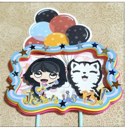 Colourful cartoon cake topper with balloons and a cat character