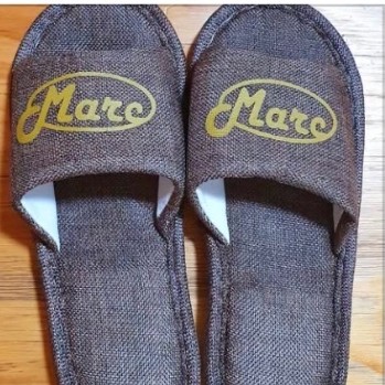 Grey linen slippers embroidered with the name Marc