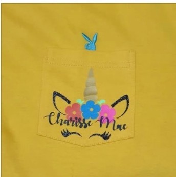 Yellow shirt with a unicorn pocket print and the name Charisse Mae